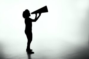 Sillouette of woman using a megaphone